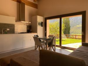 a kitchen and dining room with a table and chairs at L'armonia della natura in Aosta