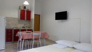 a kitchen with a table and chairs and a tv at Josipa in Crikvenica