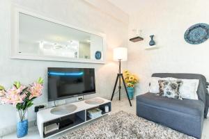 a living room with a tv and a couch at Apartment 4You in Budva