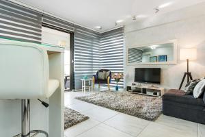 a living room with a couch and a tv at Apartment 4You in Budva