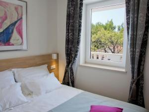 a bedroom with a bed and a window at Villa Dalmatina - Adults Only in Bol +40 photos