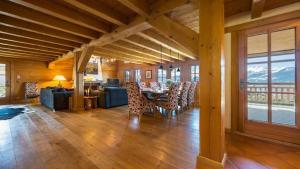a dining room and living room with a table and chairs at Chalet Dunmore in Verbier