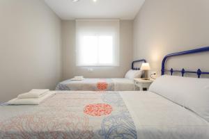 Łóżko lub łóżka w pokoju w obiekcie ALTAMAR Sunny Home by Cadiz4Rentals