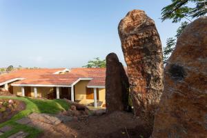 a large rock in front of a house at Nisarg Resort in Kolhapur