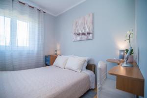 a bedroom with a bed and a desk and a window at Apartment with Terrace in Filipana in Marčana