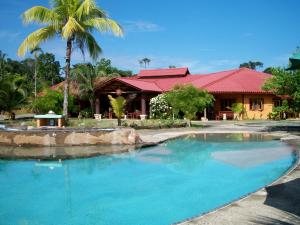 a large swimming pool in front of a house at Popa Paradise Beach Resort in Buena Vista