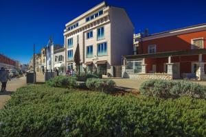 a building on the side of a street at Apartments Riva-Interauto in Umag