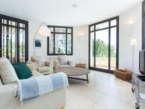 a living room with a couch and a table at TarracoHomes, Villa with Botanic Garden and Private Pool facing the Beach in Miami Platja