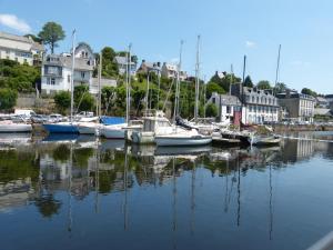 a group of boats are docked in a harbor at village insolite tiny in Saint-Benoît-des-Ondes