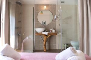 a bathroom with a sink and a mirror at Kalamata Art Rooms in Kalamata