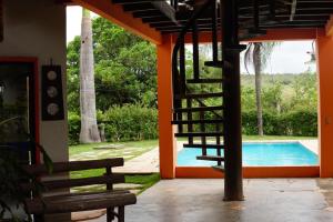 a staircase leading to a house with a swimming pool at Pousada Águas de Março in Sao Jorge