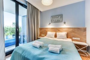 a bedroom with a bed with two pillows on it at Lion Apartments - Naviflat Apartament Okrzei 21 in Sopot