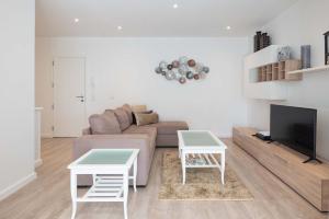 - un salon avec un canapé et deux tables dans l'établissement Apartamento Pita by HR Madeira, à Funchal