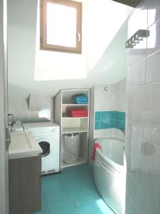 a bathroom with a sink and a washing machine at Les Toits du Capitole - Loft de standing 60 m2 - Parking en option in Toulouse
