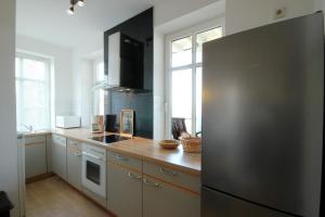 a kitchen with a black refrigerator in a kitchen at Villa Strandblick by Rujana in Binz