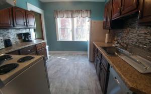 a kitchen with a sink and a refrigerator at Boulevard Park Apartments in Erie