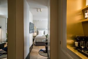a hotel room with a bedroom with a bed at Maison Armance - Esprit de France in Paris