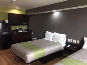 a hotel room with two beds and a kitchen at Studio 6 Burleson in Burleson