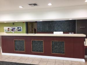 a lobby with a counter in a hospital at Studio 6 Burleson in Burleson