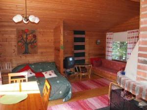 um quarto com uma cama e um sofá numa cabina em Holiday Home Raanumökki 4 by Interhome em Lampsijärvi