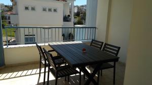 a black table and chairs on a balcony at Chalkida Apartments in Chalkida