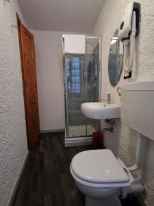 a bathroom with a toilet and a sink and a mirror at il Magàn - Cinque Terre in Corniglia