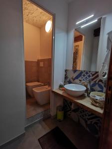 a bathroom with a sink and a toilet and a mirror at il Magàn - Cinque Terre in Corniglia