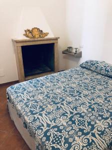 a bedroom with a bed with a fireplace in it at La Casa Di Matilde-Centre of Todi in Todi