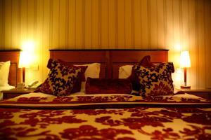 a bedroom with a large bed with pillows on it at The Fairview Boutique Hotel in Killarney
