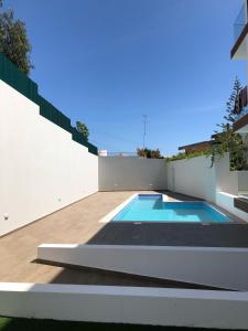 a swimming pool in the backyard of a house at Rera Alvor Deluxe Apartments in Alvor