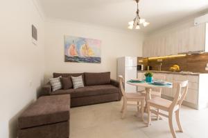 a living room and kitchen with a couch and a table at Pithos Apartments in Vóthon