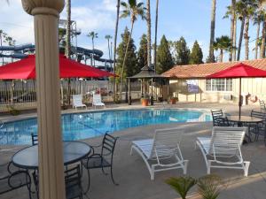 a pool with tables and chairs and a water park at Best Inn & Suites in Anaheim