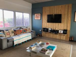 a living room with a couch and a table at Turtles Nest Villa in Treasure Beach