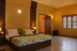 a bedroom with a bed and a window at Water's Edge Villas in Alleppey +48 photos