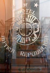 a reflection of a clock in a store window at Hotel Antica Repubblica in Amalfi center at 100mt from the sea with payment parking in Amalfi