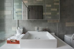 a bathroom with a white sink and a toilet at MH48 Hotel in Kenting +41 photos