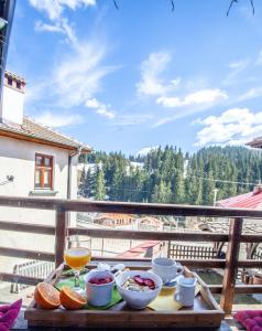 a table with bowls of food and a glass of wine at Kutsinska House in Progled