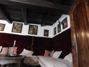 a room with two beds and pictures on the wall at Babamúzeum 4 fős apartman in Tihany