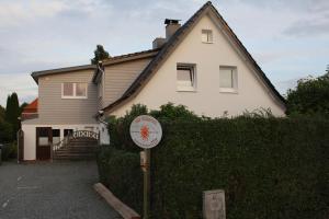 a white house with a sign in front of it at Ferienwohnung 3 in Dahme