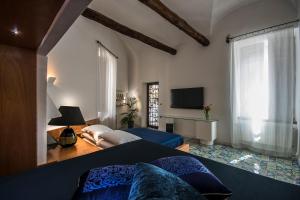 a bedroom with a bed and a television in it at VILLA DURANTE in Ercolano