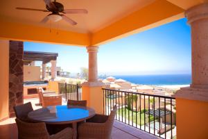 a balcony with a table and chairs and the ocean at Pueblo Bonito Montecristo Luxury Villas - All Inclusive in Cabo San Lucas