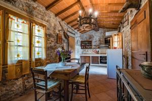 a kitchen with a table and chairs and a refrigerator at Fattoria Ceragioli in Camaiore