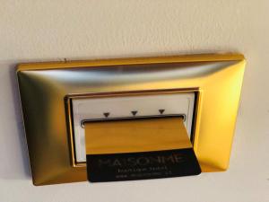 a metal box with a sign on a wall at MaisonMe Boutique Hotel in Bardolino