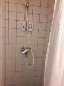 a shower in a bathroom with a shower curtain at Hamina Orange Apartments Loft in Hamina