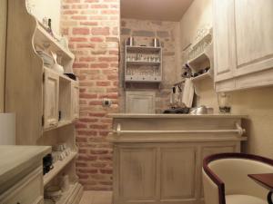 a kitchen with a sink, stove, cabinets and a refrigerator at Hotel Villa Duomo in Kotor