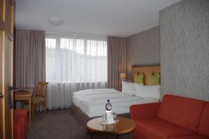 Postel nebo postele na pokoji v ubytování Hotel Ettrich & Elbresort Rathen