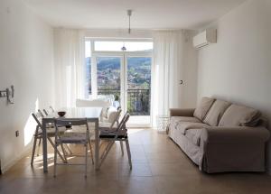 a living room with a table and a couch at Villa Regina Serafina in Balchik