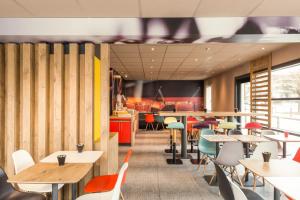 a restaurant with tables and chairs and a counter at ibis Troyes Centre in Troyes