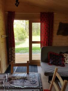 a living room with a couch and a window at Camping Family in Bronowice