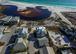 an aerial view of a beach with houses and the water at Little Blue in Santa Rosa Beach